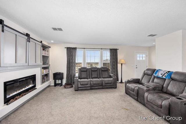 living room with light carpet and a barn door