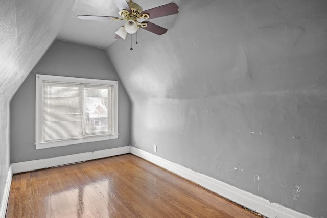 additional living space featuring lofted ceiling, light hardwood / wood-style floors, and ceiling fan