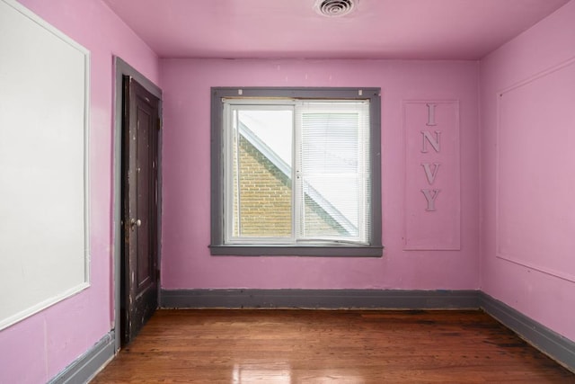 empty room featuring dark hardwood / wood-style flooring