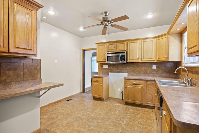 kitchen with sink, decorative backsplash, dishwasher, and ceiling fan