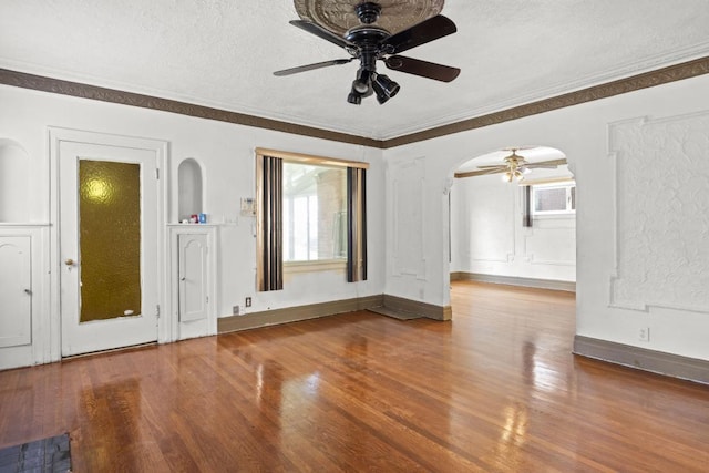 unfurnished living room featuring crown molding, ceiling fan, hardwood / wood-style floors, and a textured ceiling