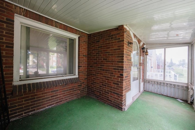 unfurnished sunroom featuring wooden ceiling