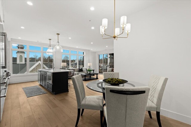 156 N Center St Unit 302, Northville, MI 48167 - dining room with light hardwood / wood-style floors and a notable chandelier