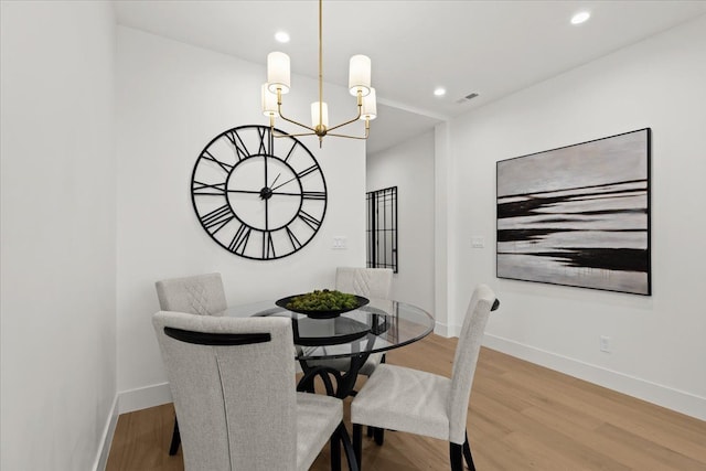 156 N Center St Unit 302, Northville, MI 48167 - dining room featuring hardwood / wood-style floors and a chandelier