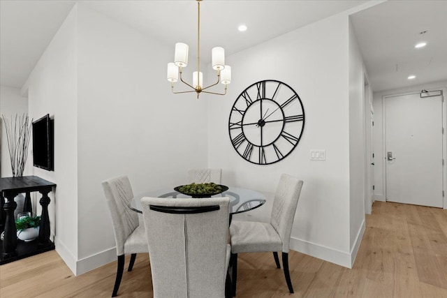 156 N Center St Unit 302, Northville, MI 48167 - dining area with an inviting chandelier and light hardwood / wood-style flooring