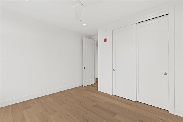 156 N Center St Unit 302, Northville, MI 48167 - unfurnished bedroom with ceiling fan, light hardwood / wood-style floors, and a closet