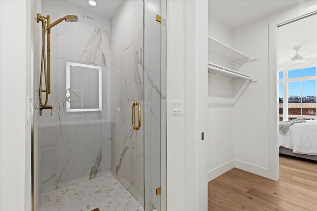 156 N Center St Unit 302, Northville, MI 48167 - bathroom featuring hardwood / wood-style floors, ceiling fan, and walk in shower