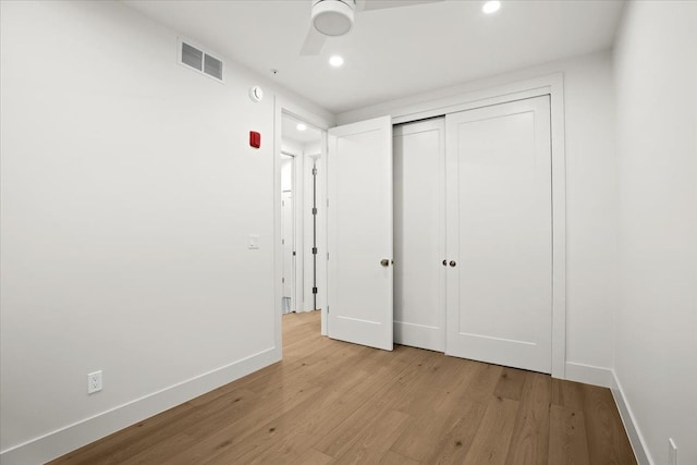 unfurnished bedroom with light hardwood / wood-style floors and a closet