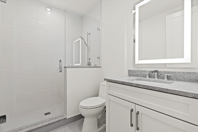 bathroom featuring vanity, an enclosed shower, tile patterned flooring, and toilet