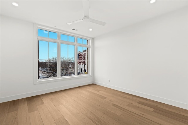 unfurnished room featuring light hardwood / wood-style flooring and ceiling fan