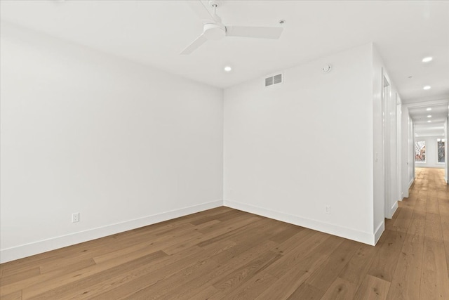 unfurnished room with ceiling fan and hardwood / wood-style floors