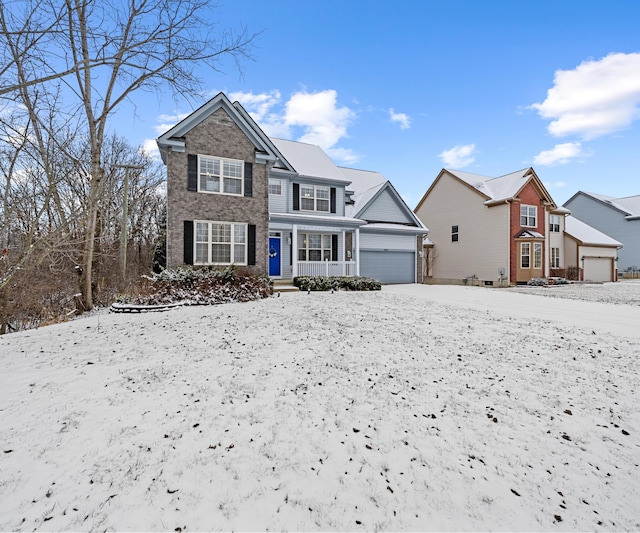 view of front of property featuring a garage and a porch