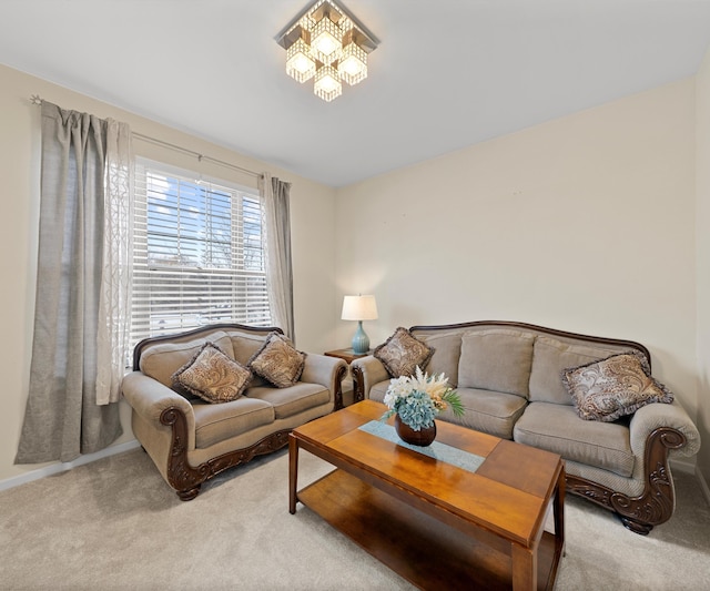 living room with a notable chandelier and light colored carpet