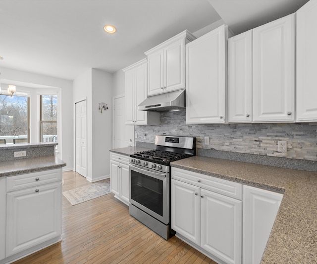 kitchen featuring tasteful backsplash, white cabinetry, stainless steel range with gas stovetop, and light hardwood / wood-style floors