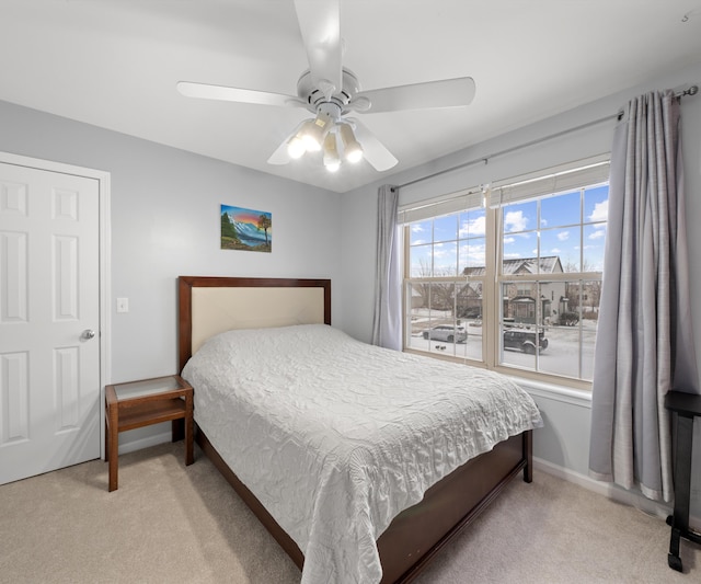 carpeted bedroom with ceiling fan