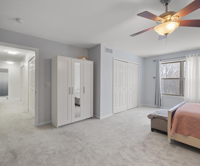 bedroom with light carpet, ceiling fan, and a closet