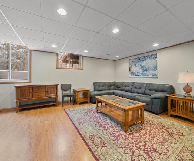 living room with a paneled ceiling and wood-type flooring