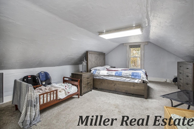 bedroom featuring lofted ceiling, light carpet, and a textured ceiling