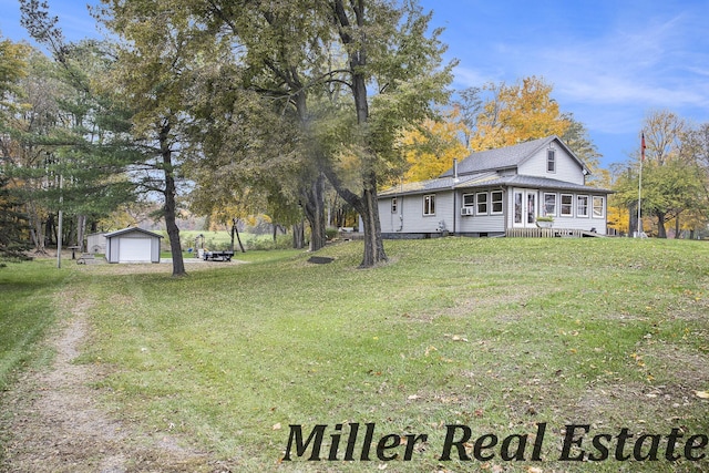 view of yard featuring an outbuilding and a garage