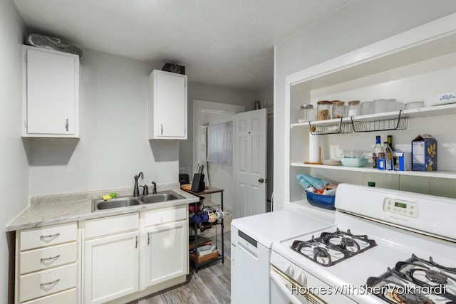 kitchen featuring sink, white appliances, and white cabinets