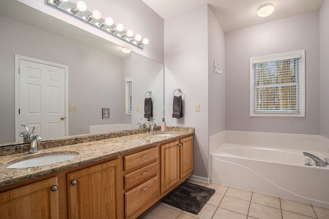 bathroom with tile patterned flooring, vanity, and a washtub