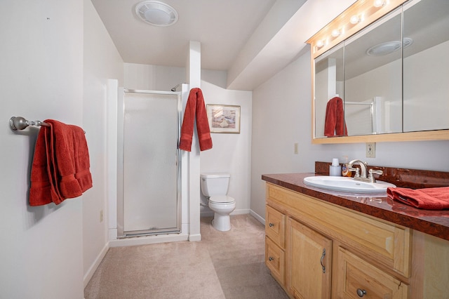 bathroom featuring vanity, an enclosed shower, and toilet