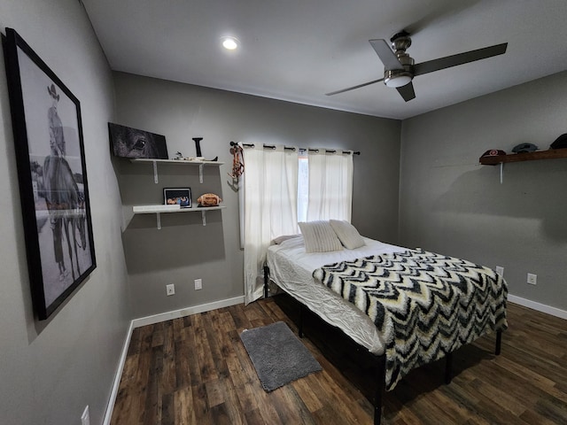 bedroom with dark hardwood / wood-style flooring and ceiling fan