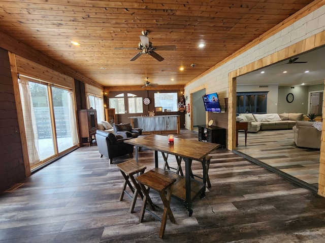 dining space featuring brick wall, ceiling fan, dark hardwood / wood-style flooring, and wood ceiling