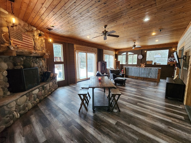 living room featuring a fireplace, wood ceiling, and dark hardwood / wood-style floors