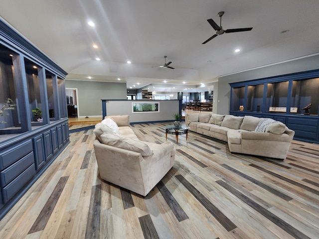 living room featuring light hardwood / wood-style floors, lofted ceiling, and ceiling fan