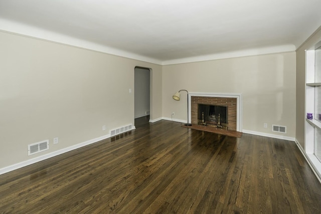 unfurnished living room with dark wood-type flooring and a fireplace