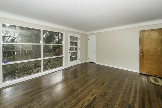 empty room with dark hardwood / wood-style floors