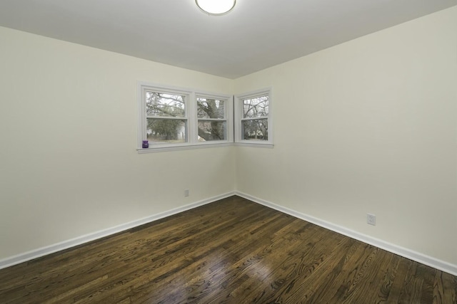 spare room featuring dark wood-type flooring