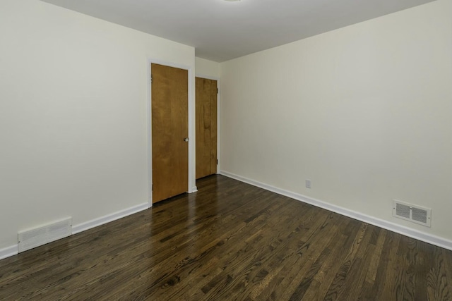 empty room with dark wood-type flooring