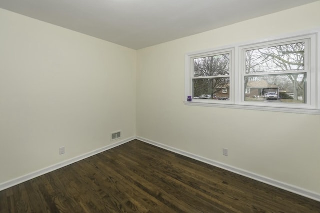 empty room with dark hardwood / wood-style floors