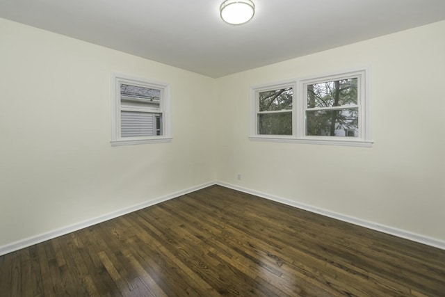 spare room featuring dark wood-type flooring