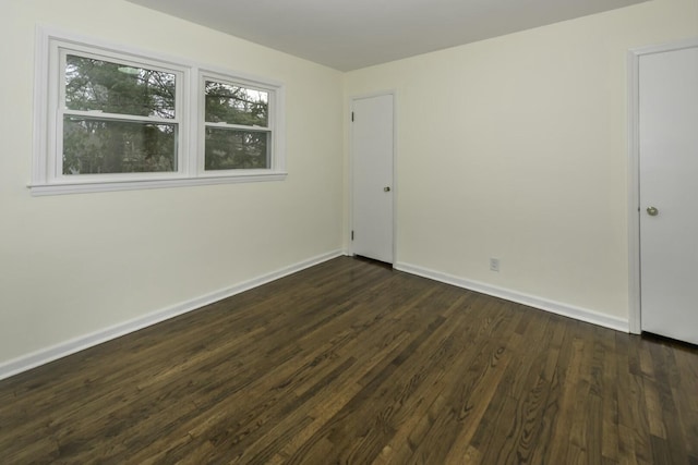 unfurnished room featuring dark hardwood / wood-style flooring