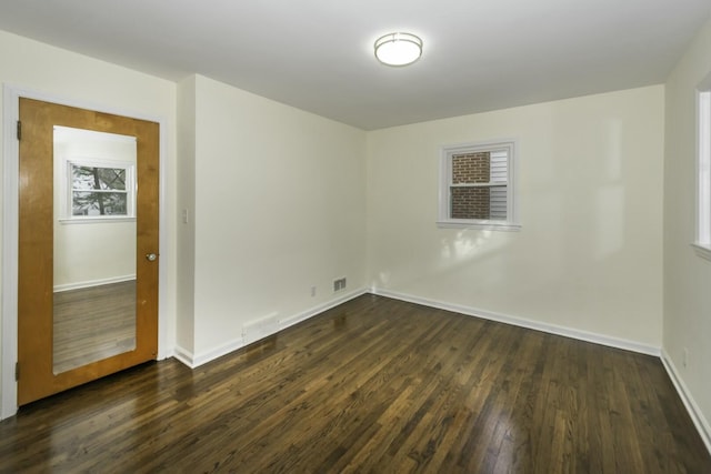 unfurnished room with dark hardwood / wood-style floors