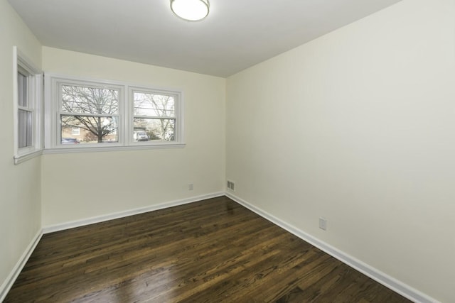 unfurnished room featuring dark wood-type flooring