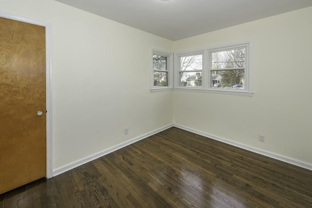 spare room featuring dark hardwood / wood-style flooring