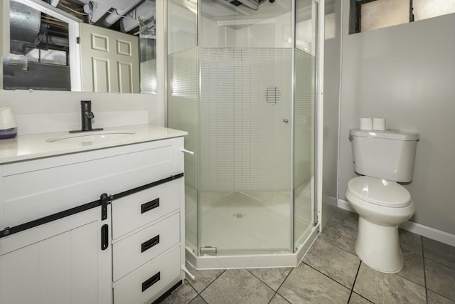 bathroom with vanity, toilet, tile patterned flooring, and a shower with door