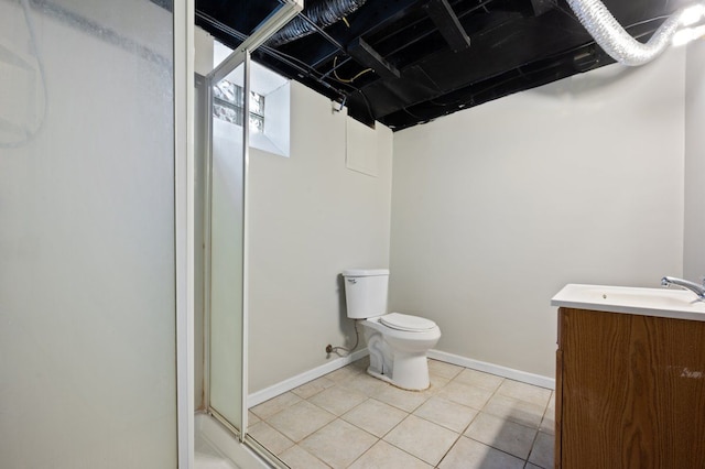 bathroom with vanity, tile patterned flooring, a shower with shower door, and toilet