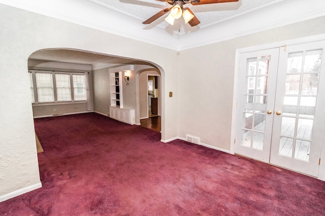 carpeted empty room with crown molding, french doors, and ceiling fan