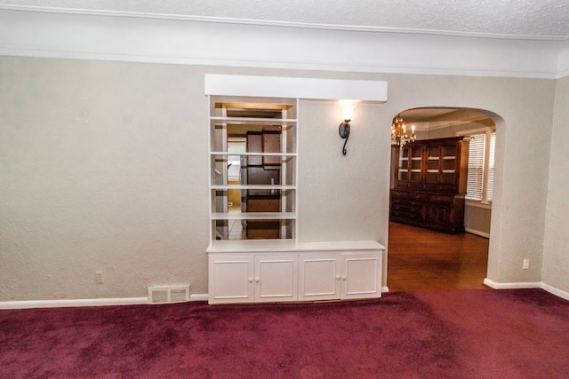 interior space featuring carpet flooring, a notable chandelier, and a textured ceiling