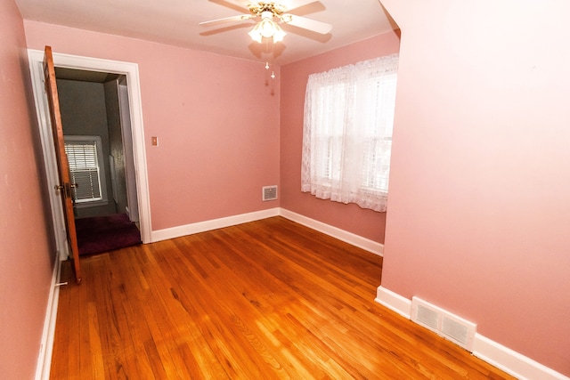 unfurnished room featuring hardwood / wood-style floors and ceiling fan