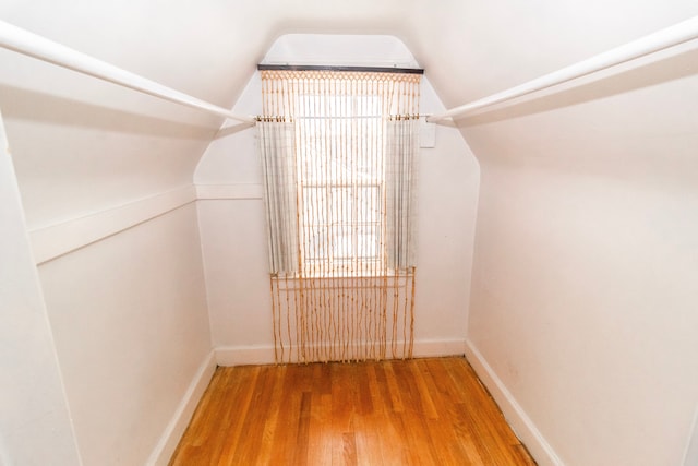 walk in closet featuring lofted ceiling and wood-type flooring