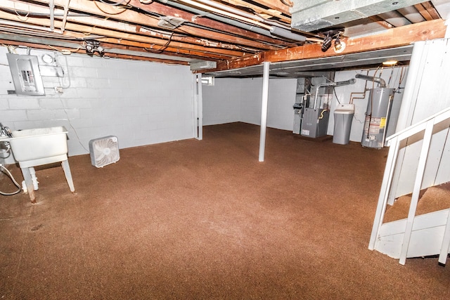 basement featuring heating unit, water heater, sink, carpet flooring, and electric panel