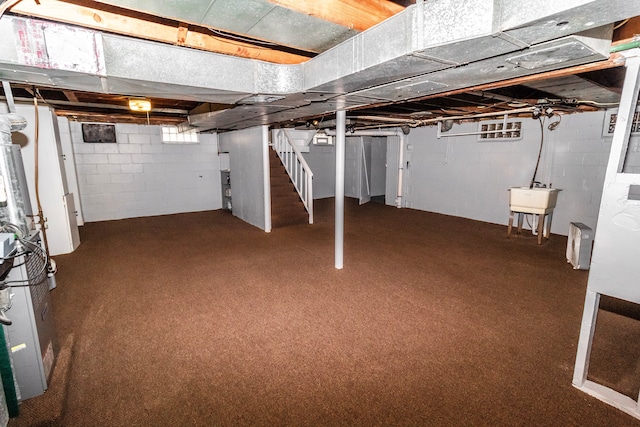 basement featuring carpet flooring and sink