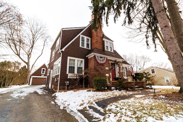 view of front of property featuring a garage and an outdoor structure