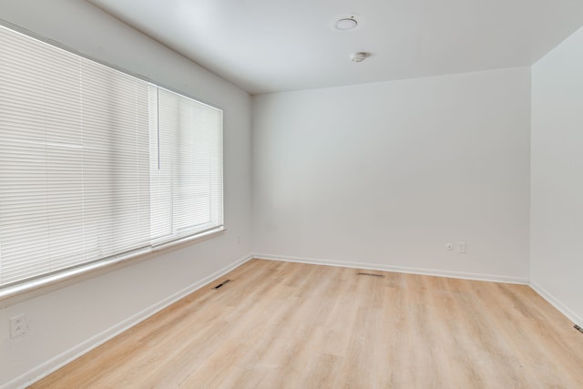 spare room featuring light hardwood / wood-style floors